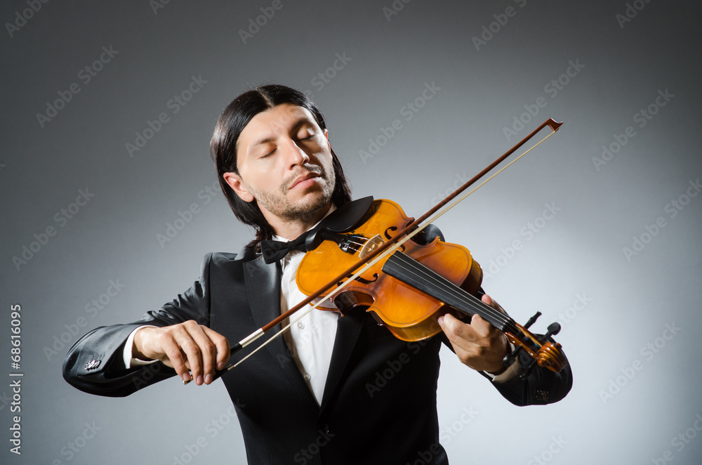 Fototapeta premium Man violin player in musican concept