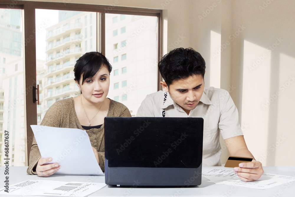 Couple paying bill online Couple paying bill online
