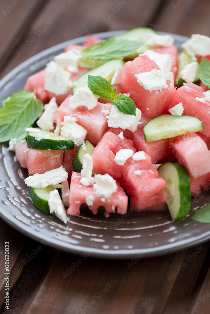 Salad with watermelon, cucumber and feta cheese, vertical shot