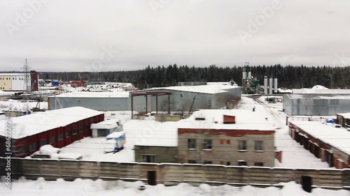 High-speed train is moving close to the warehouse area (POV) photo