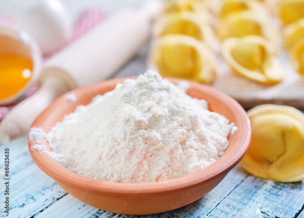 flour and raw pelmeni flour and raw pelmeni