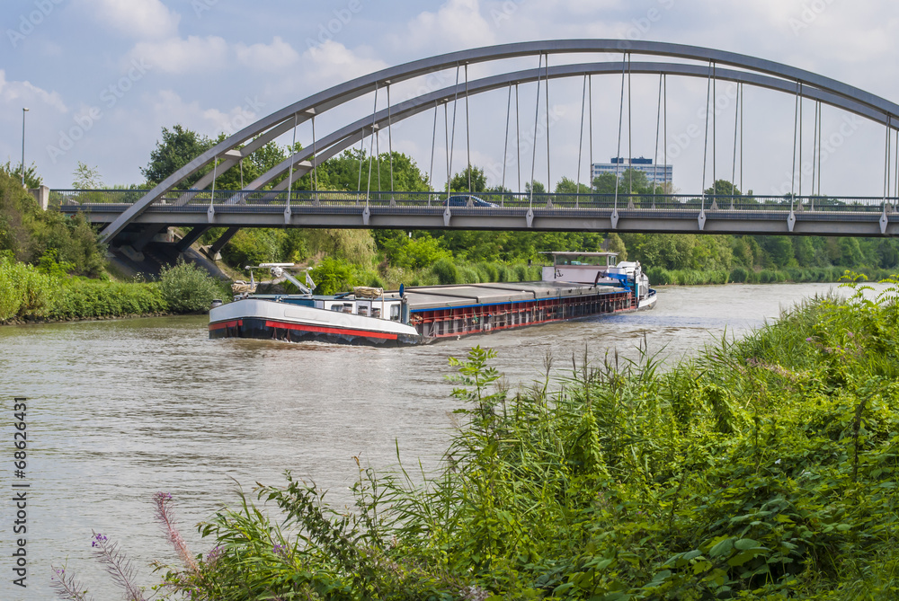 Fototapeta premium Cargo ship on the canal