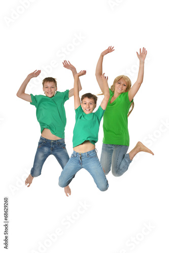 Mother and sons jumping in studio