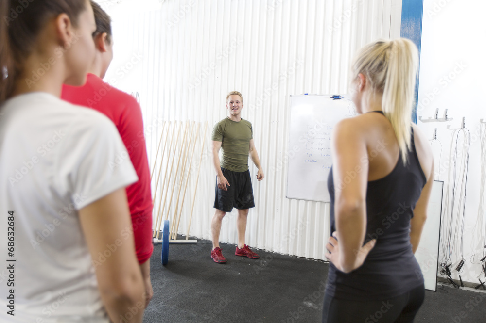 Personal trainer instructs fitness workout team Personal trainer instructs fitness workout team