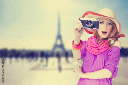 Redhead women with scarf and vintage camera on Parisian backgrou © Masson