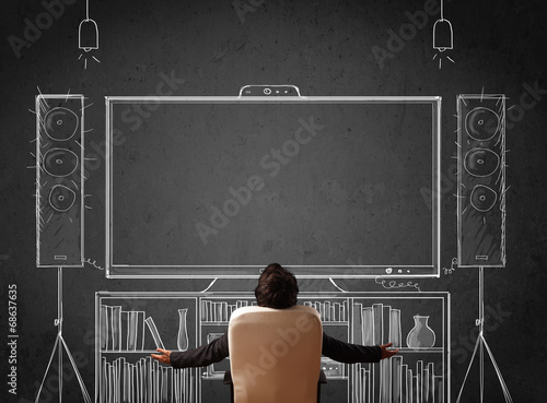 Slika na platnu Businessman in front of a home cinema system