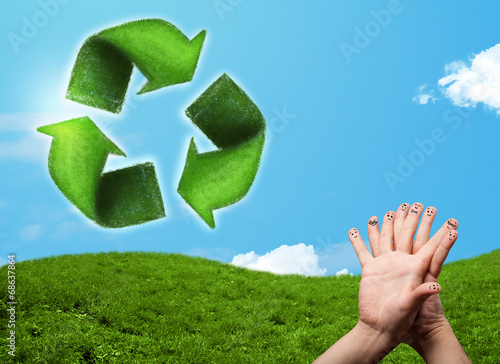 Happy smiley fingers looking at green leaf recycle sign