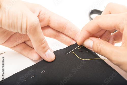 woman sews clothes hands