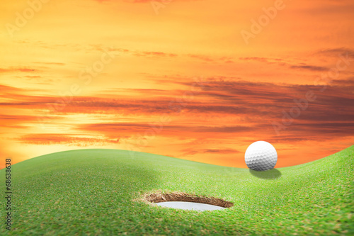 golf ball and hole on a field