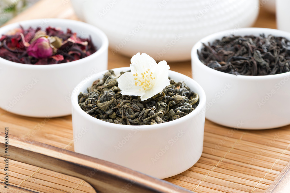 dry herbal teas in white bowls on a tray - obrazy, fototapety, plakaty 