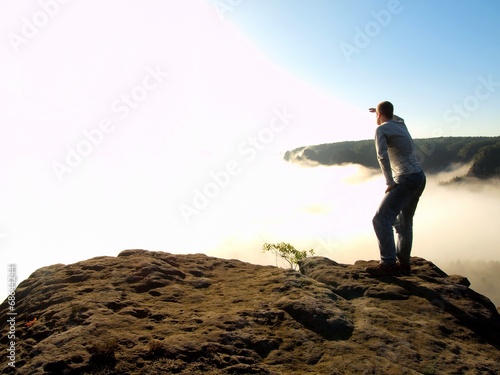 Man stand on the peak of sandstone rock in national park