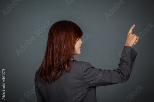 Side view of Asian business woman touching the screen
