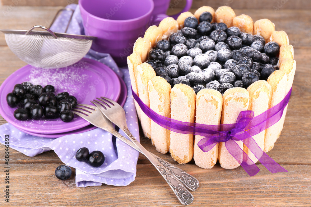 Tasty cake Charlotte with blueberries on wooden table Tasty cake Charlotte with blueberries on wooden table
