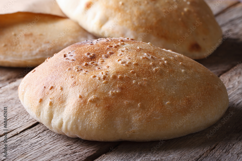 freshly baked pita bread on the wooden table closeup freshly baked pita bread on the wooden table closeup