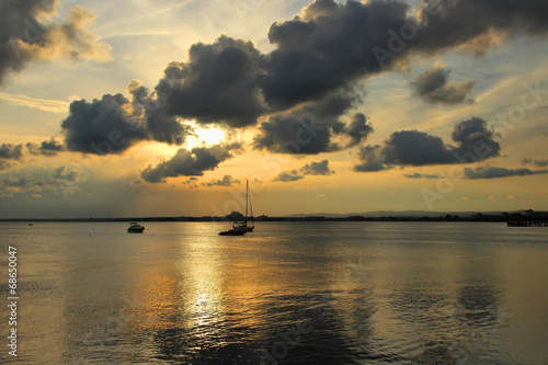 Beautiful sunset and yacht, drifting at sea. © victoriashuba