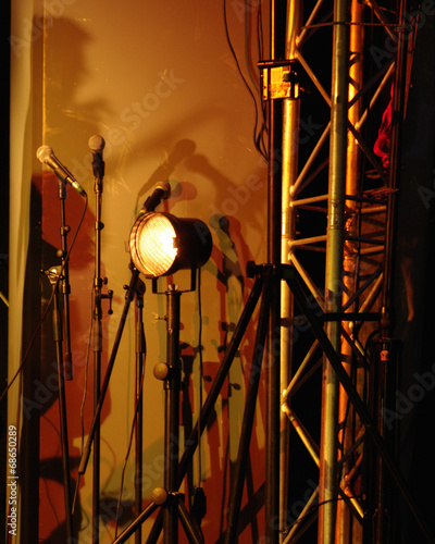 Lamp and few microphones on stage during concert