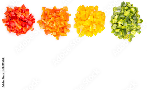 Fotografie Heaps of chopped colorful capsicums over white background