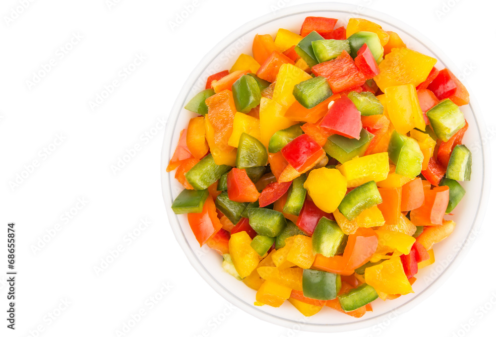 Mix colorful chopped capsicum in a bowl over white background Mix colorful chopped capsicum in a bowl over white background
