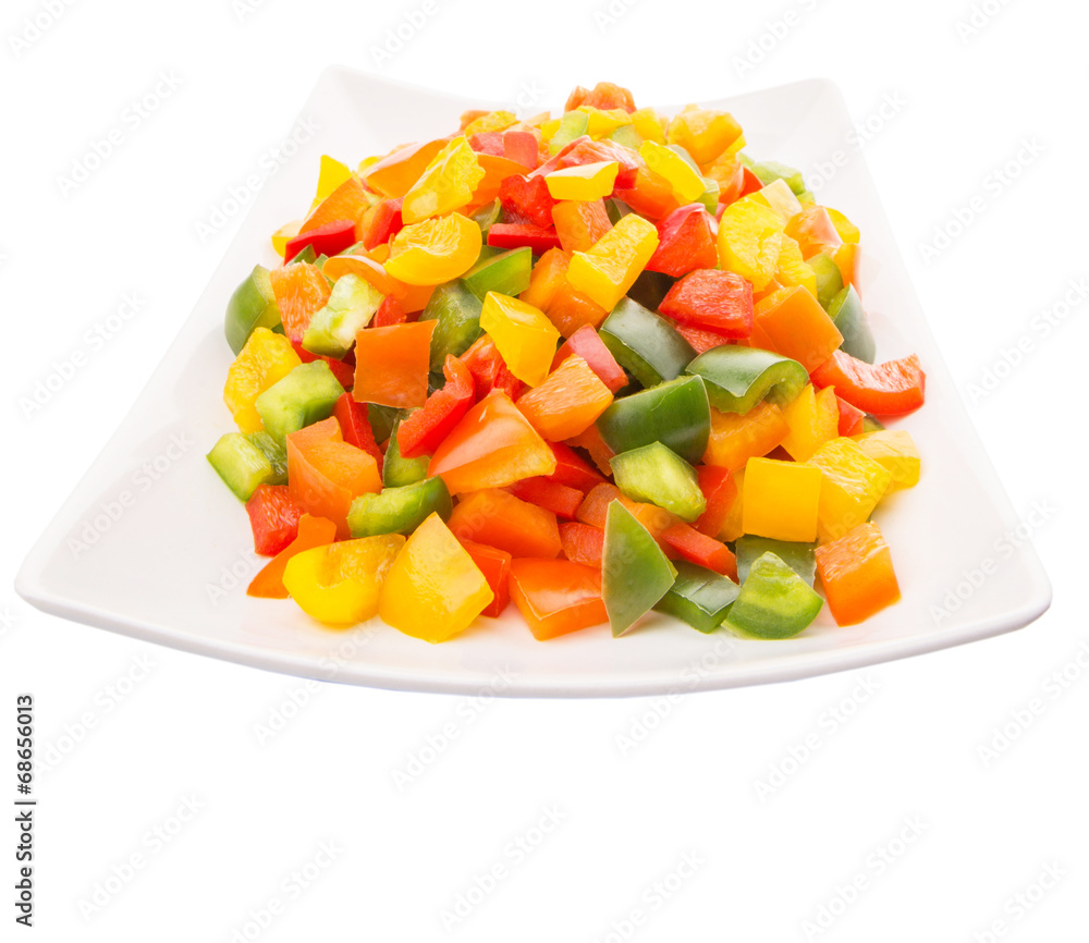 Mix colorful chopped capsicums in a plate over white background