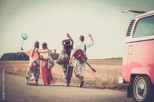 Canvas Print Multi-ethnic hippie friends with guitar and luggage