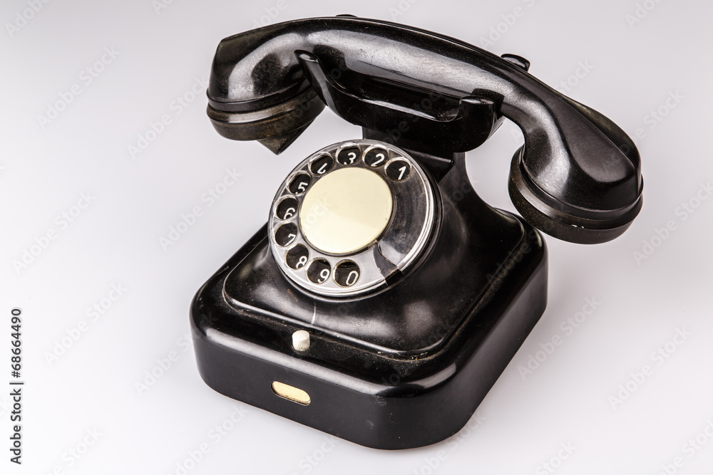 Old black phone with dust and scratches on white background Old black phone with dust and scratches on white background