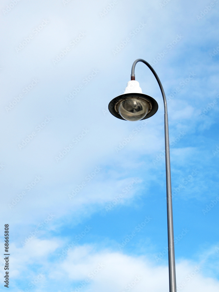 Outdoor public lighting pole with blue sky on background Outdoor public lighting pole with blue sky on background