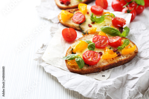 Tasty bruschetta with tomatoes, on table