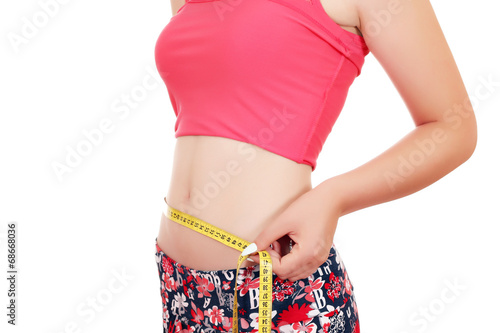 young woman measuring her waist