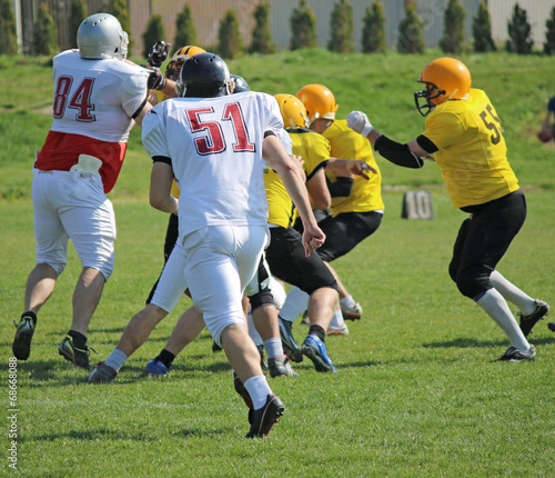 american football players running on field