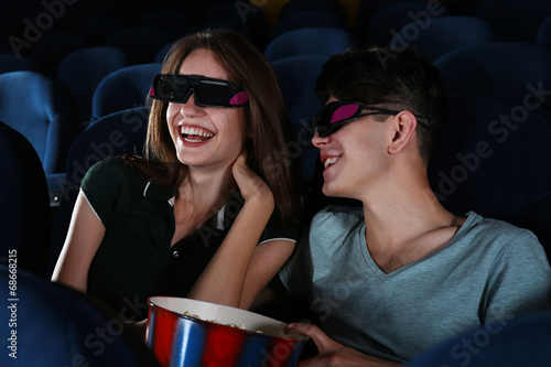 Young couple watching movie...
