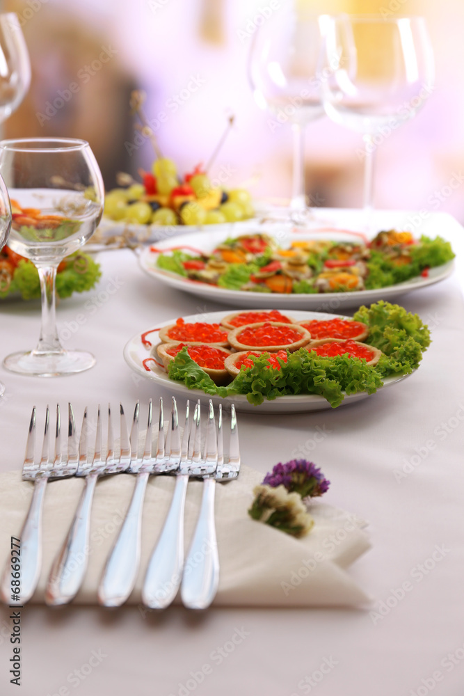 Buffet table with dishware waiting for guests Buffet table with dishware waiting for guests