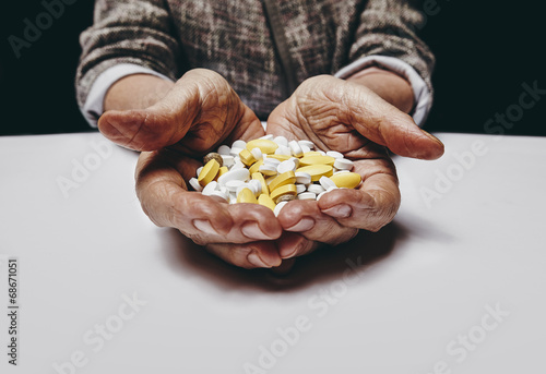 Senior woman hands with pills