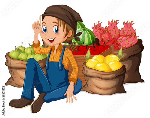 A young farmer near his harvested fruits