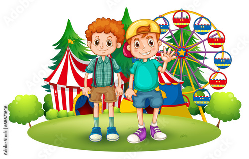 Two boys in front of the carnival