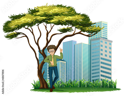 A man standing under the tree across the offices