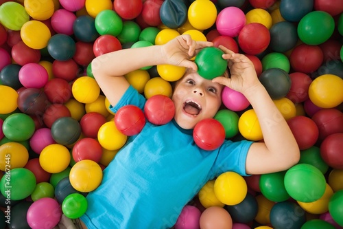 Happy boy playing in ball pool