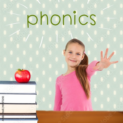 Phonics against red apple on pile of books