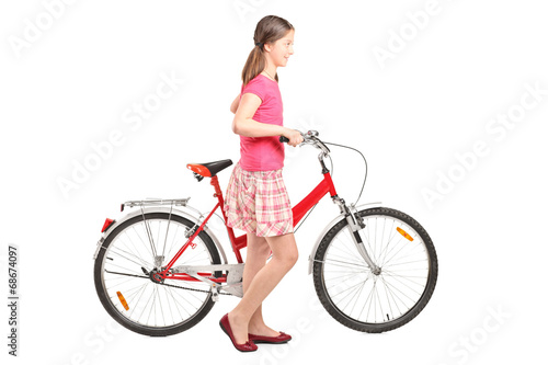 Young girl pushing a bike