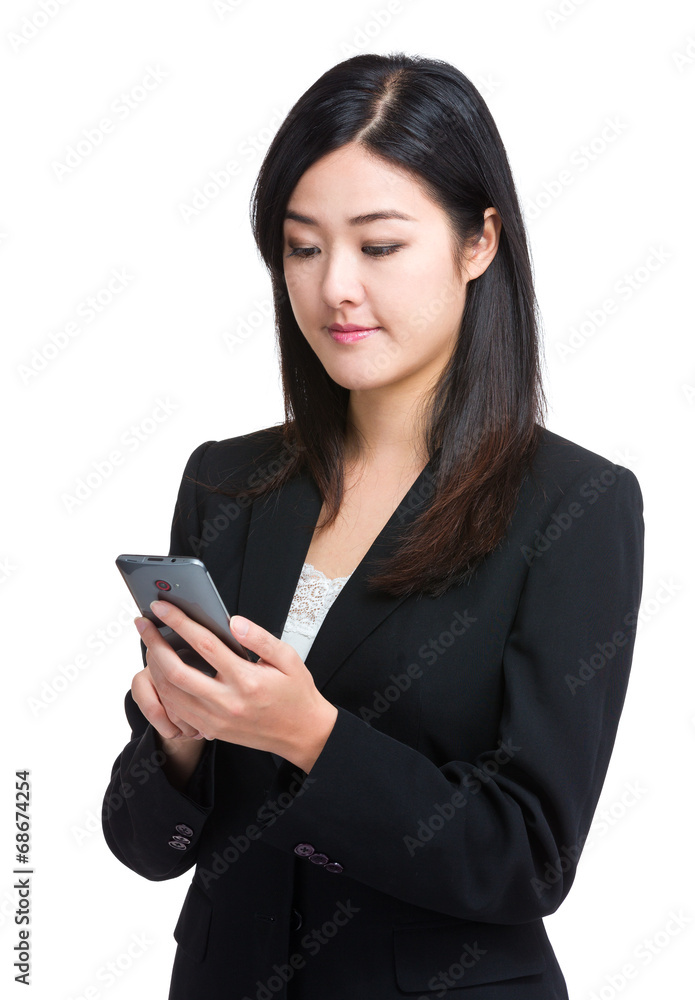 Asian businesswoman send message on celllphone Asian businesswoman send message on celllphone