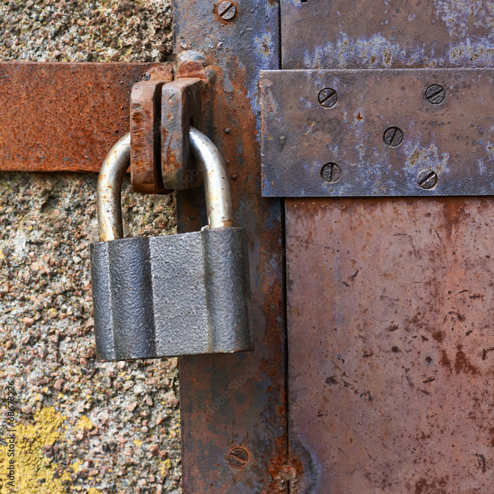 Old metal door closed with a lock Old metal door closed with a lock