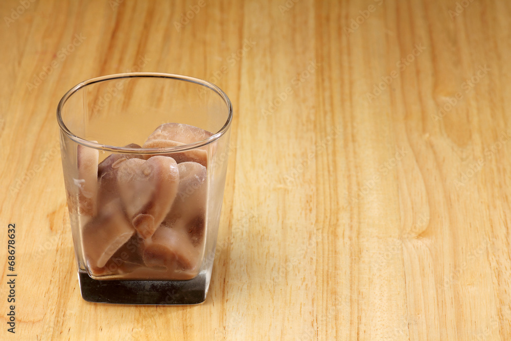 ice chocolate heart shape in glass drink on wood desk ice chocolate heart shape in glass drink on wood desk