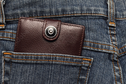 brown leather wallet in the pocket of jeans