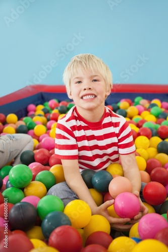 Happy boy playing in ball pool