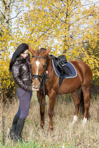 equestrian with her horse in autumnal nature
