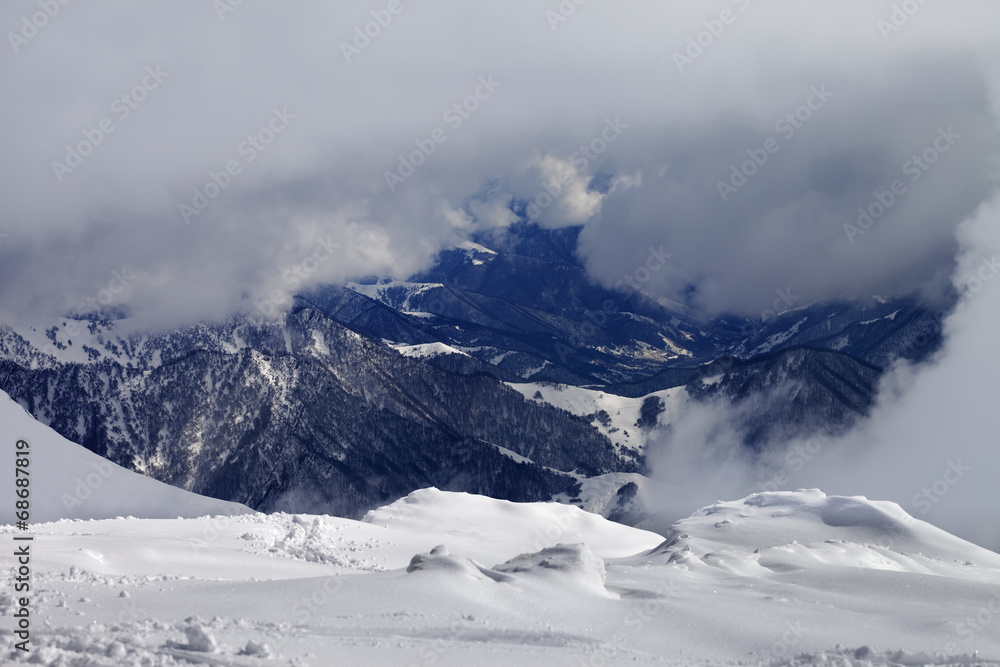 Winter snowy mountains in clouds Winter snowy mountains in clouds