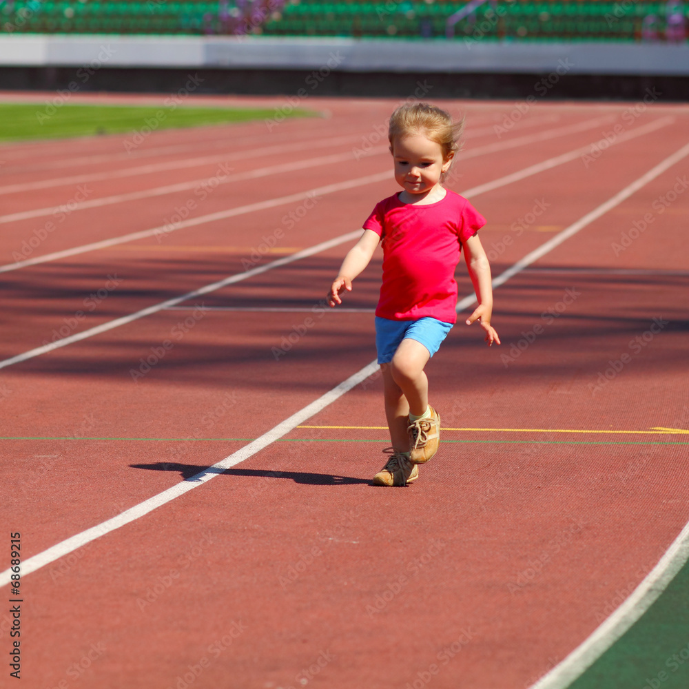 little girl child involved in athletics at the stadium