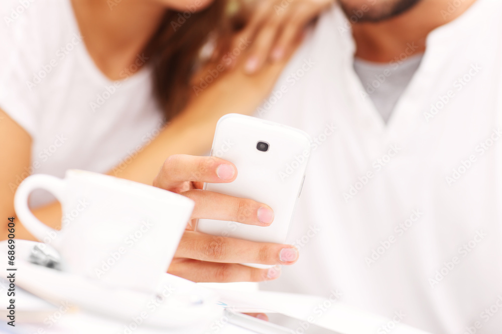 Closeup of hands and smartphone in a cafe Closeup of hands and smartphone in a cafe
