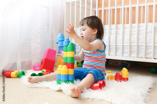 baby boy age of 22 months playing toys at home