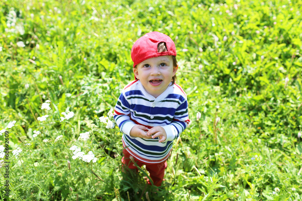lovely baby standing on grass and looking up lovely baby standing on grass and looking up
