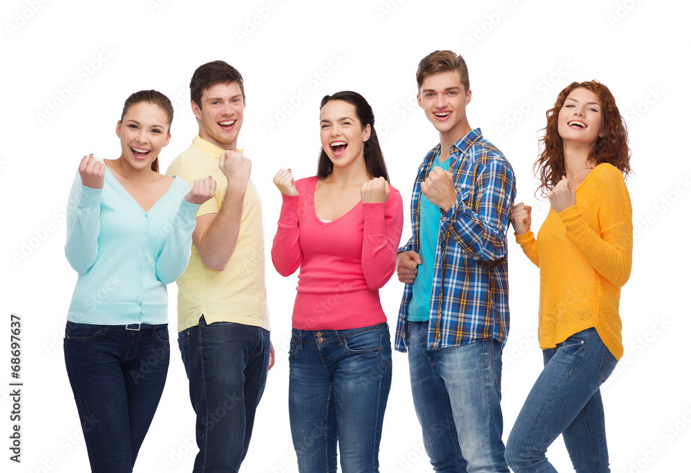 group of smiling teenagers showing triumph gesture group of smiling teenagers showing triumph gesture